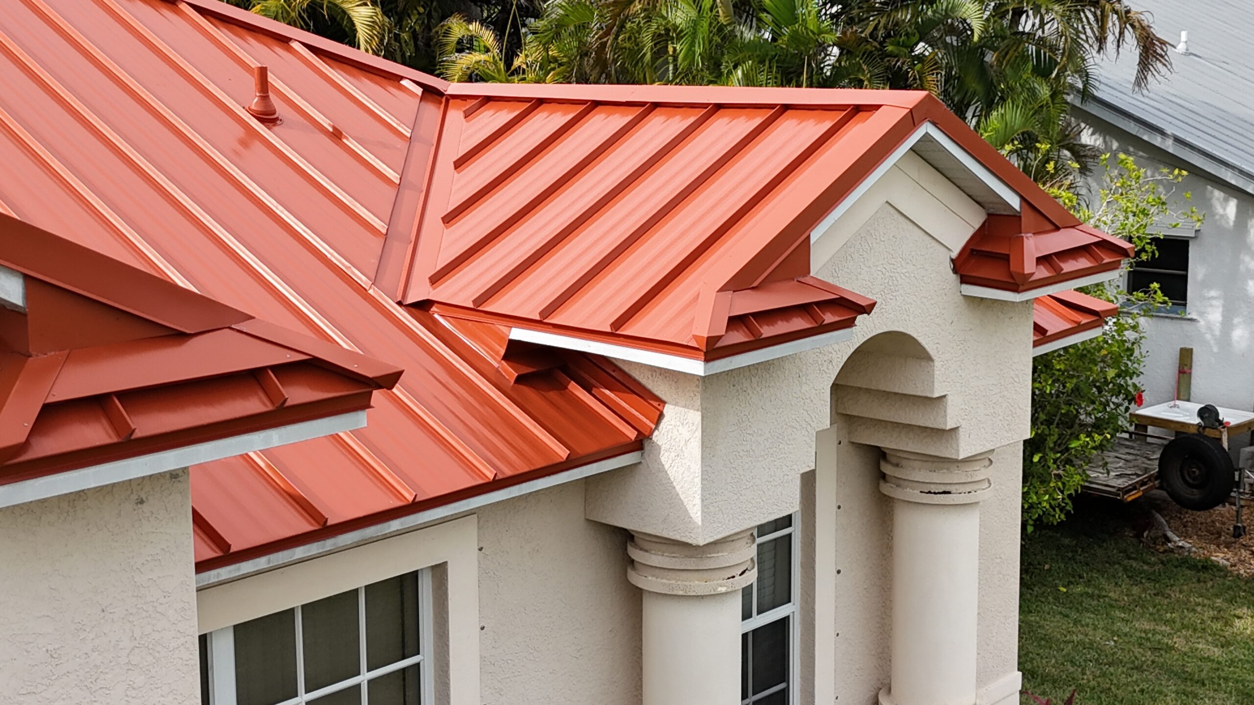 A newly installed metal roof with a terracotta finish.
