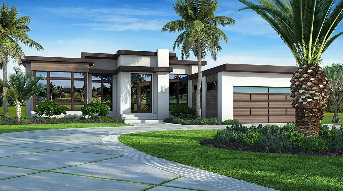 A modern white and brown one-story luxury home with a flat roof, large glass windows, and a wood-paneled garage door, surrounded by palm trees and a manicured lawn.
